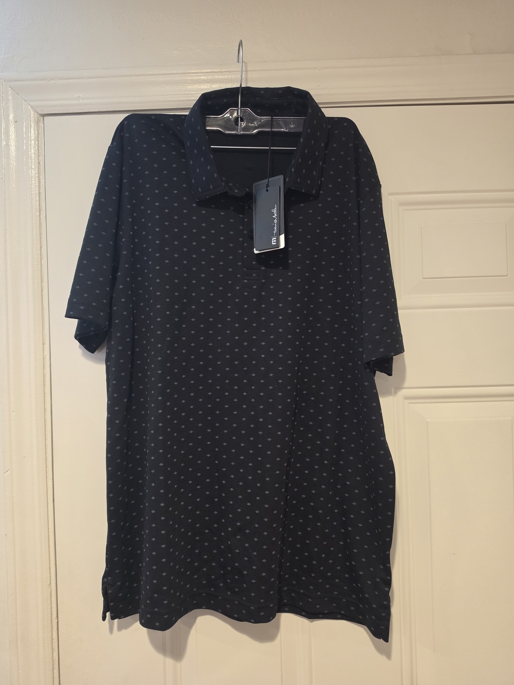 Men's Black Travis Mathew Polo Shirt with Micro Dot Pattern